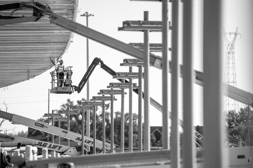 construction worker on boom in black and white