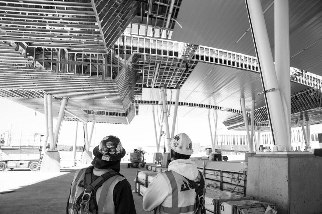 customs car port in black and white with construction workers