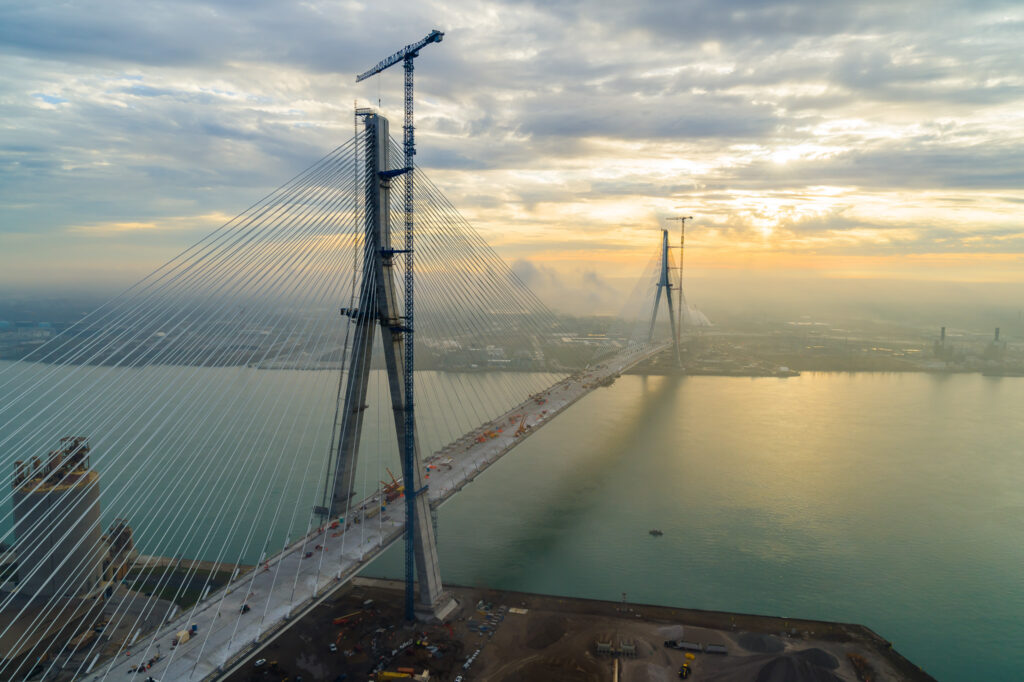 view of bridge construction with sun setting