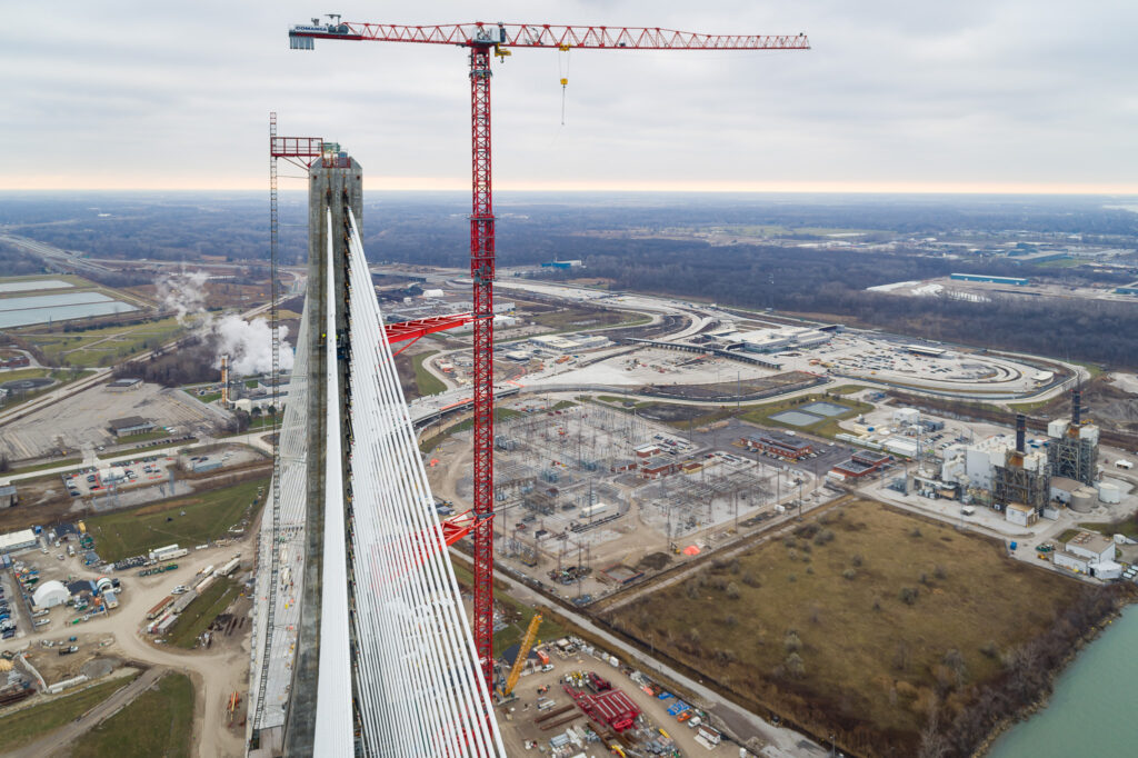 image of red crane beside the bridge