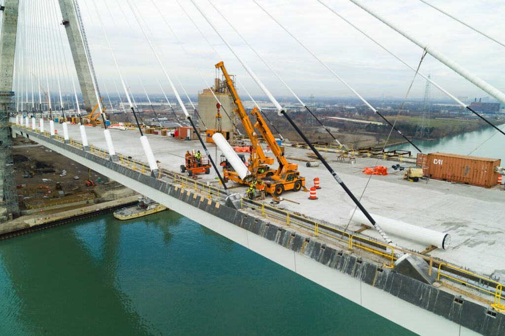 workers with mini cranes moving item