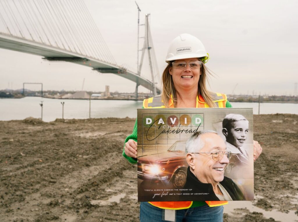 lady holding a sign of old man