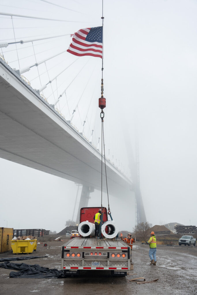 Crane lifting material with the American flag on it