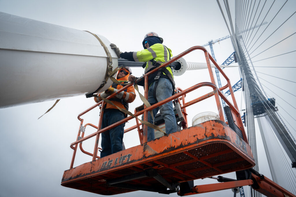 workers fixing the suspension cables