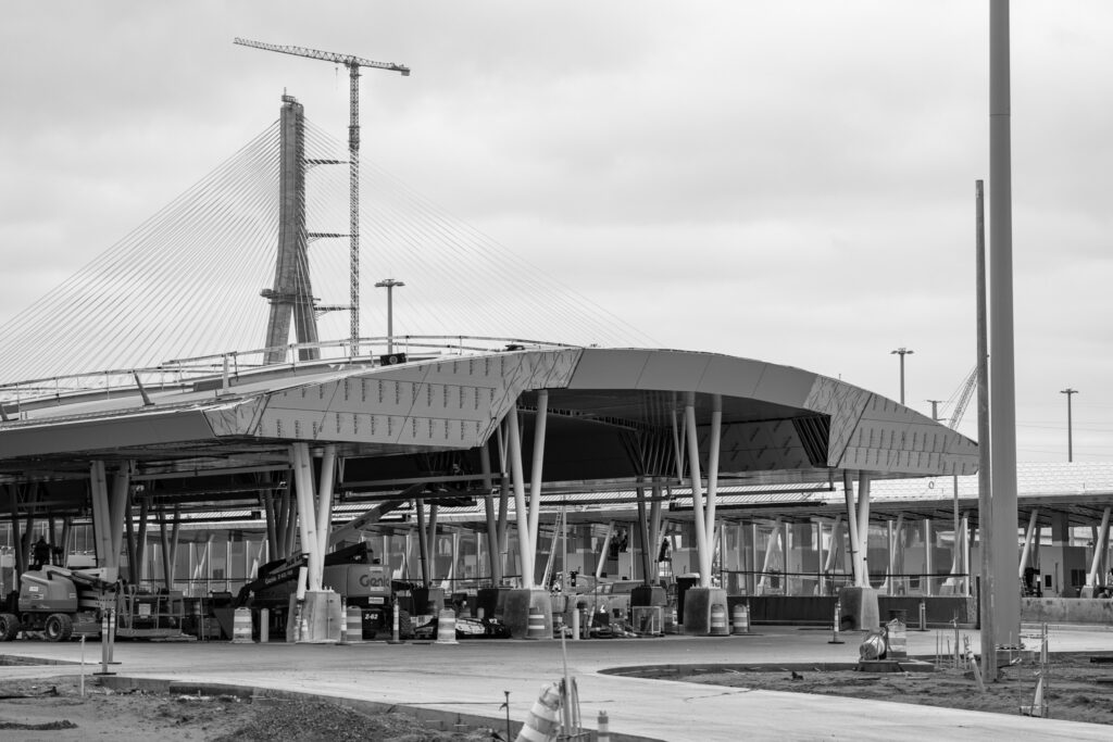 customs with bridge in background in black and white