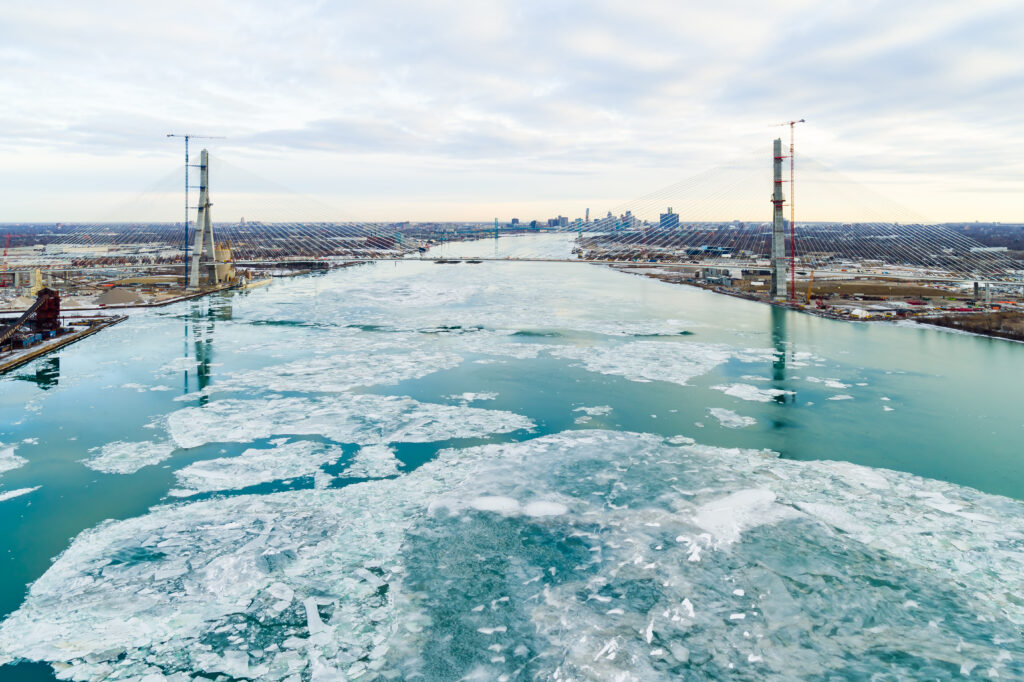view of bridge in the distance with massive ice sheet in river