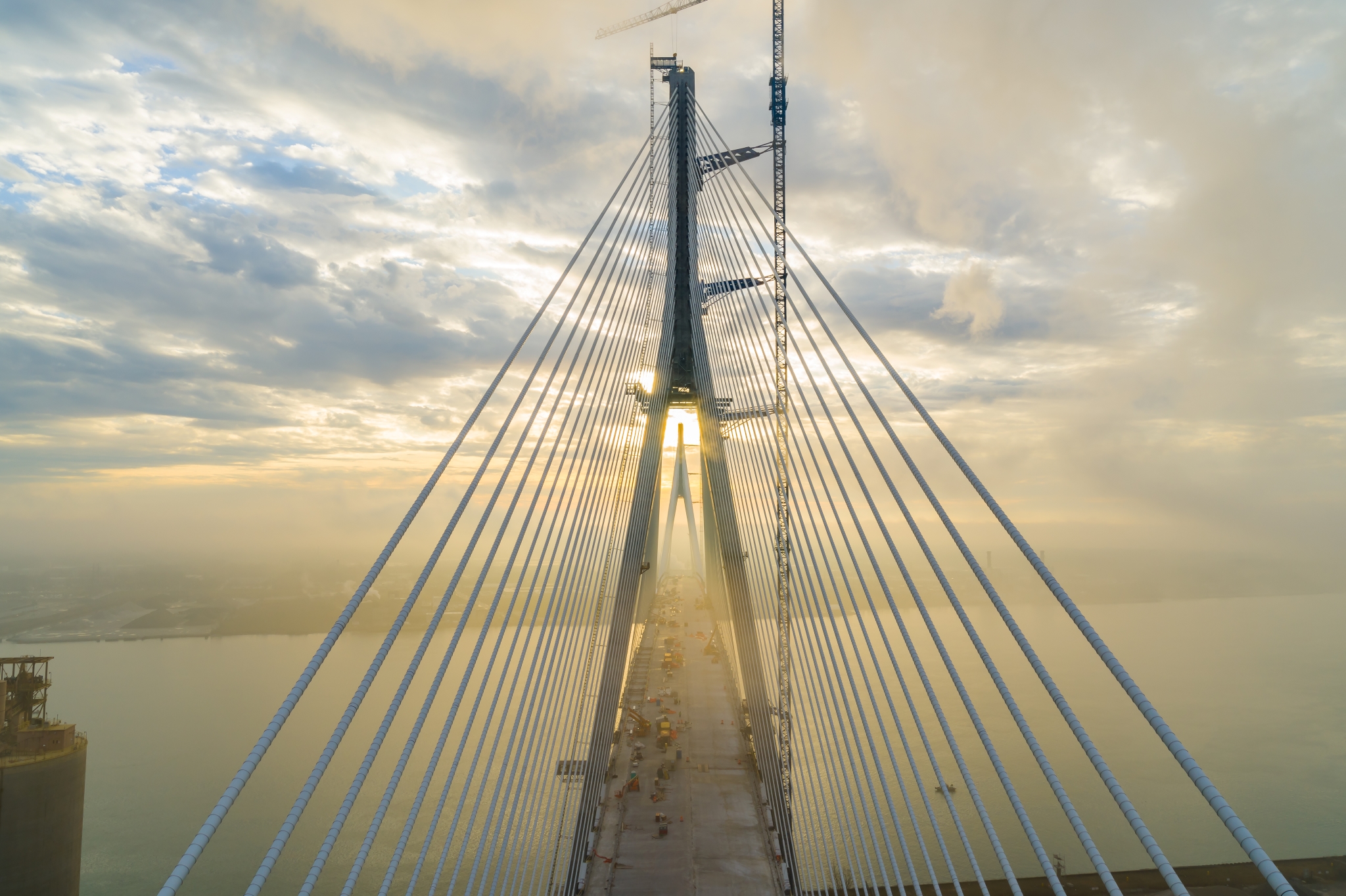looking down bridge span from the air with sunset happening