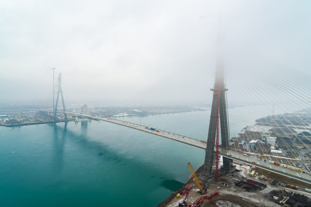 full view of bridge with clouds around the mast