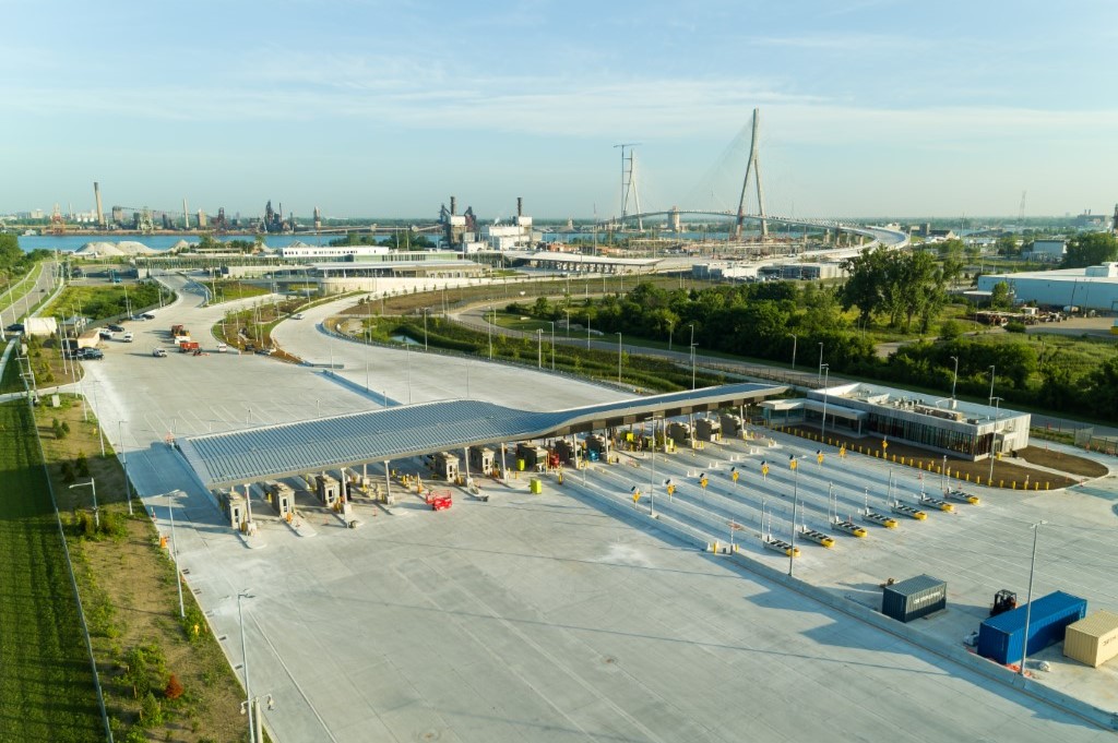 A picture of toll lanes with the Gordie Howe International Bridge in the background.