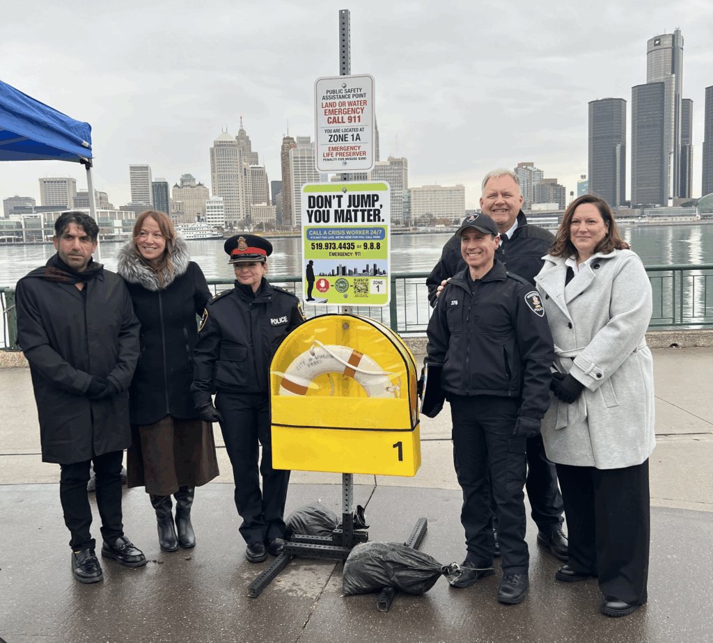 This image displays Windsor-Detroit Bridge Authority and partners unveil a green sign with suicide prevention messaging.